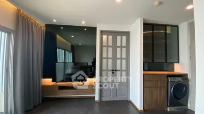 Modern living room with sleek TV setup and built-in washing machine