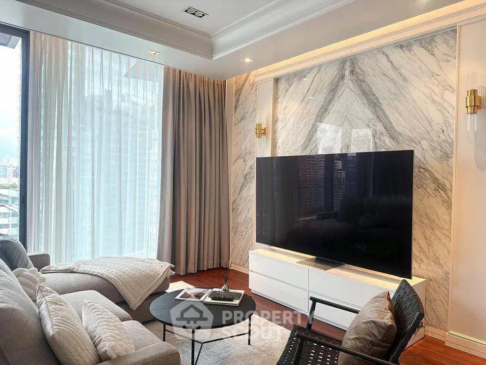 Luxurious living room with marble accent wall and large TV, featuring modern furniture and floor-to-ceiling windows.