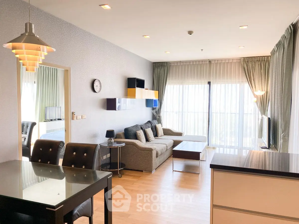 Spacious modern living room with elegant decor and large windows for natural light.