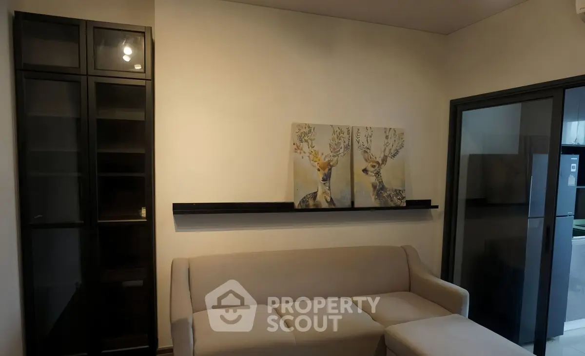 Modern living room with elegant sofa and deer artwork, perfect for stylish urban living.