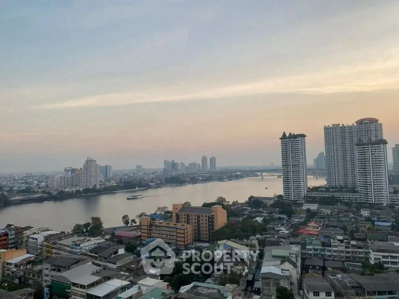 Stunning cityscape view with river and high-rise buildings at sunset, perfect for urban living enthusiasts.