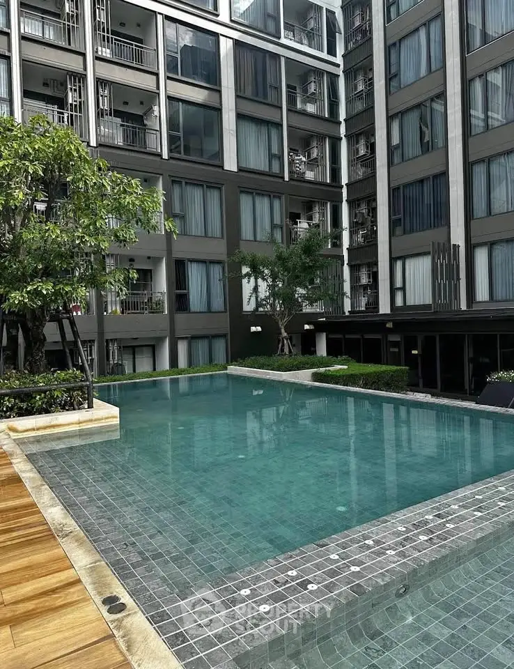 Modern apartment complex with luxurious pool and lush greenery