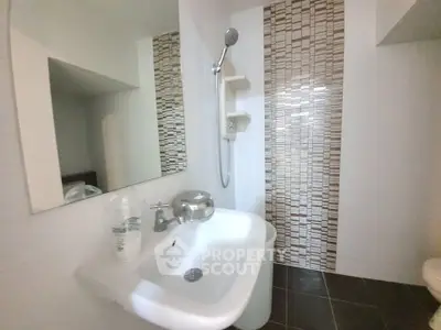 Modern bathroom with stylish tile accent wall and sleek fixtures
