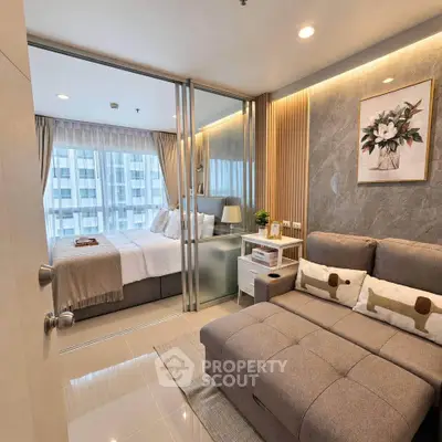 Modern bedroom with stylish decor and cozy seating area in a high-rise apartment.