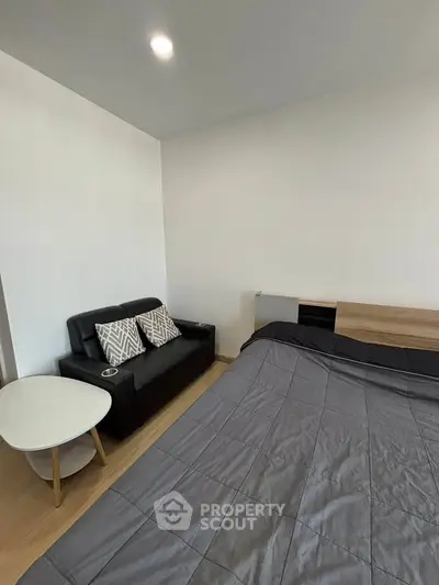 Modern bedroom with cozy sofa and stylish decor