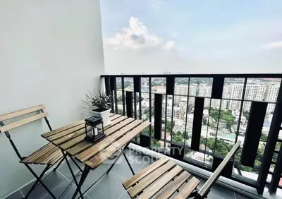 Charming balcony with city view, featuring wooden furniture and potted plant.