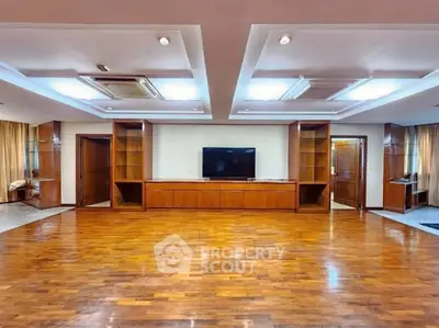 Spacious living room with wooden flooring and built-in TV unit