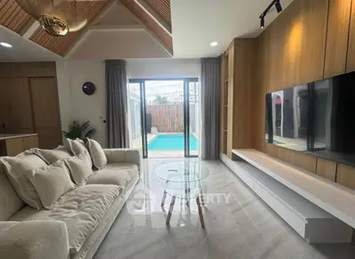 Modern living room with pool view, elegant decor, and natural light.