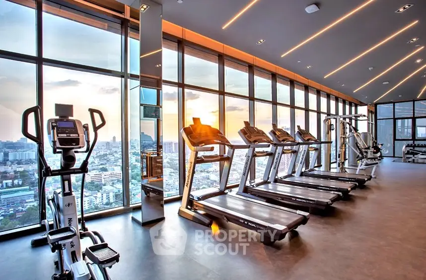 Luxurious high-rise gym with panoramic city views and modern fitness equipment.