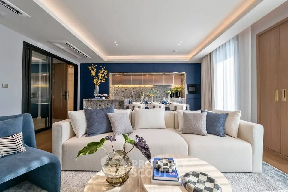 Luxurious modern living room with elegant decor and open kitchen layout, perfect for stylish urban living.