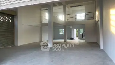 Spacious industrial-style open space with mezzanine and large windows