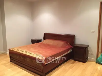 Spacious bedroom with wooden furniture and elegant decor
