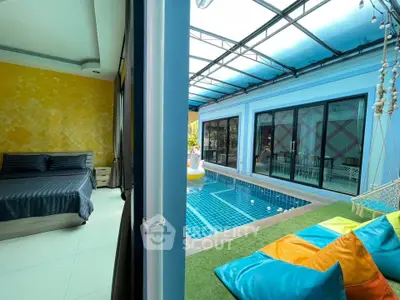 Luxurious poolside view with vibrant bean bags and cozy bedroom, perfect for relaxation and leisure.