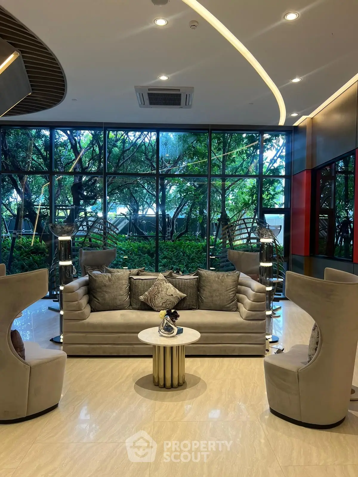 Luxurious modern living room with elegant furniture and lush garden view.