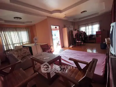 Spacious living room with natural light and cozy furnishings