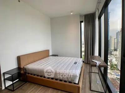 Modern bedroom with city view and large windows in high-rise apartment