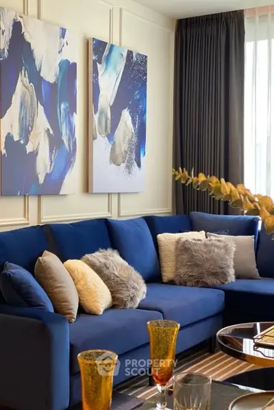 Luxurious living room with blue sectional sofa and abstract art, perfect for modern living.