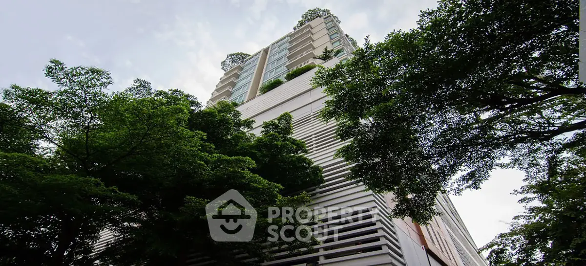 Stunning modern high-rise building surrounded by lush greenery, offering a serene urban living experience.