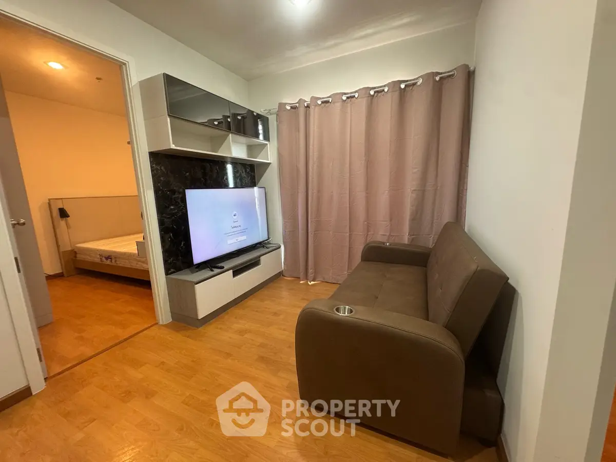 Cozy living room with modern TV unit and comfortable sofa in a stylish apartment.