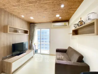 Modern living room with wooden ceiling, sleek TV unit, and balcony access in a stylish apartment.