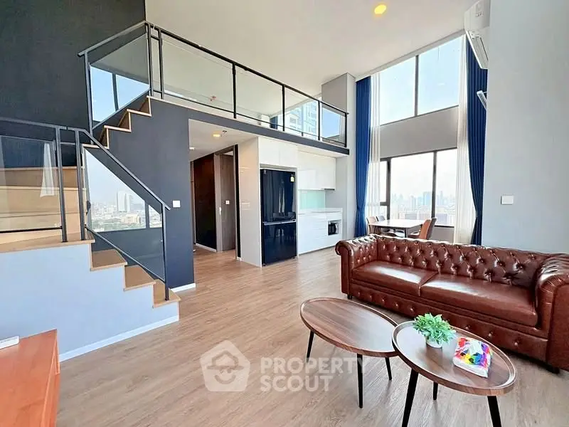 Stunning modern loft with high ceilings and panoramic city views, featuring a stylish open-plan living area and sleek kitchen.