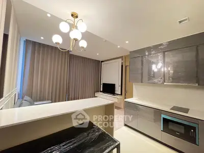 Modern open-layout kitchen with sleek cabinetry and elegant lighting
