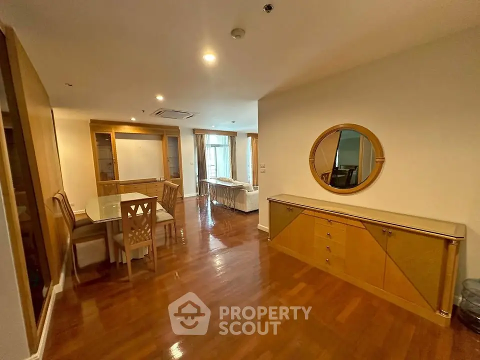 Spacious living room with elegant wooden flooring and modern dining area