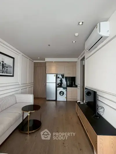 Modern living room with sleek furniture and integrated kitchen appliances