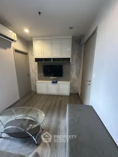 Modern living room with sleek furniture and built-in TV unit, perfect for urban living.