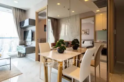Modern apartment interior with dining area and city view, featuring elegant decor and natural light.
