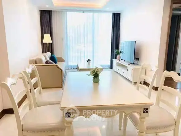 Elegant living room with dining area, stylish furniture, and natural light.