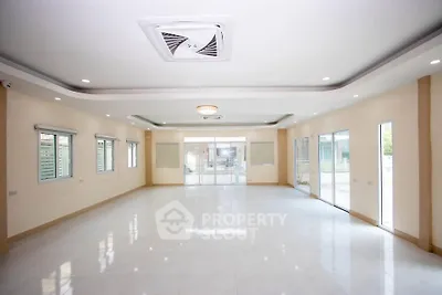 Spacious modern living room with large windows and elegant ceiling design