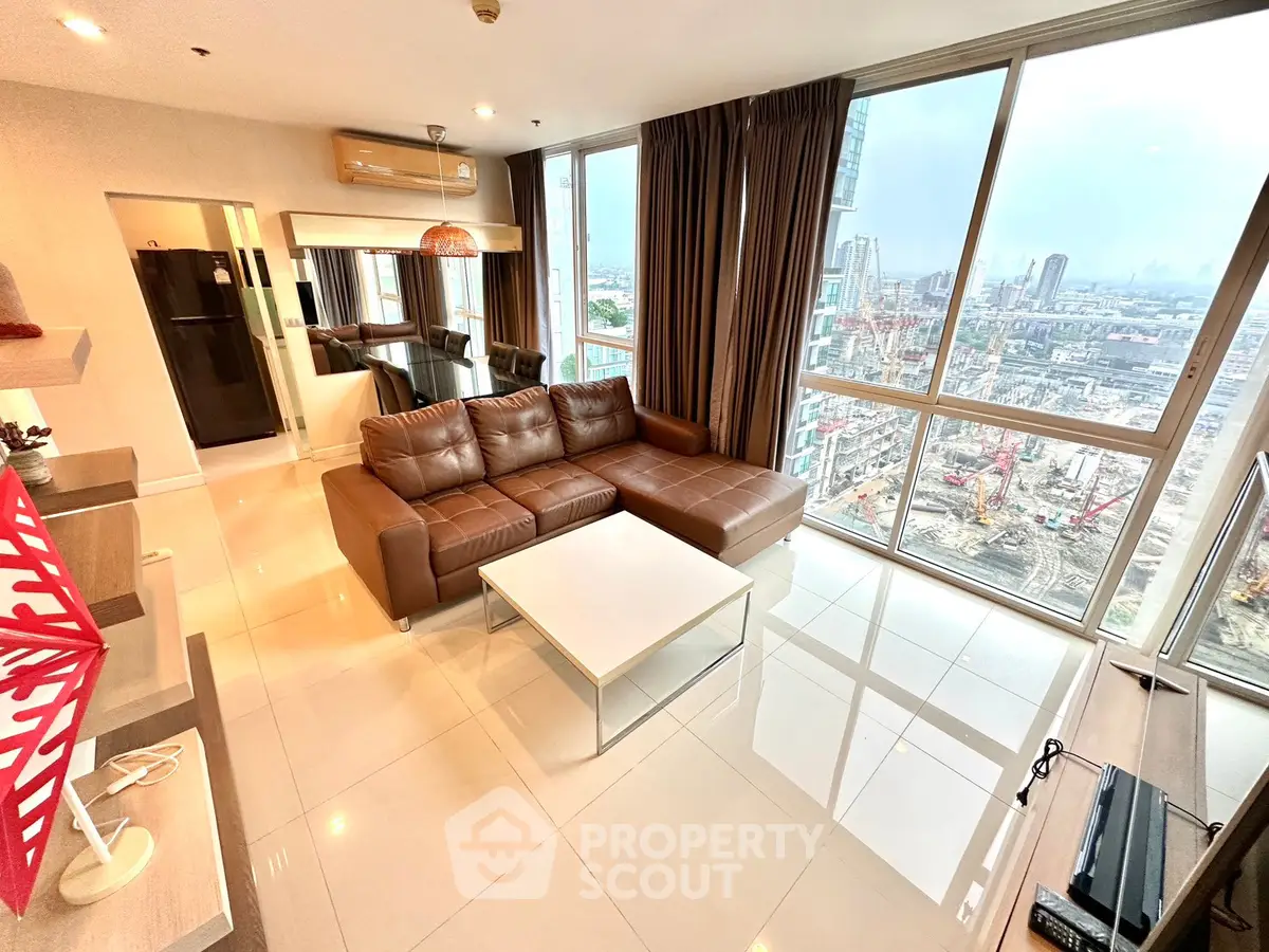 Luxurious high-rise living room with stunning city view and modern furnishings.