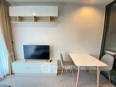 Modern living room with sleek TV unit and dining table, perfect for cozy gatherings.