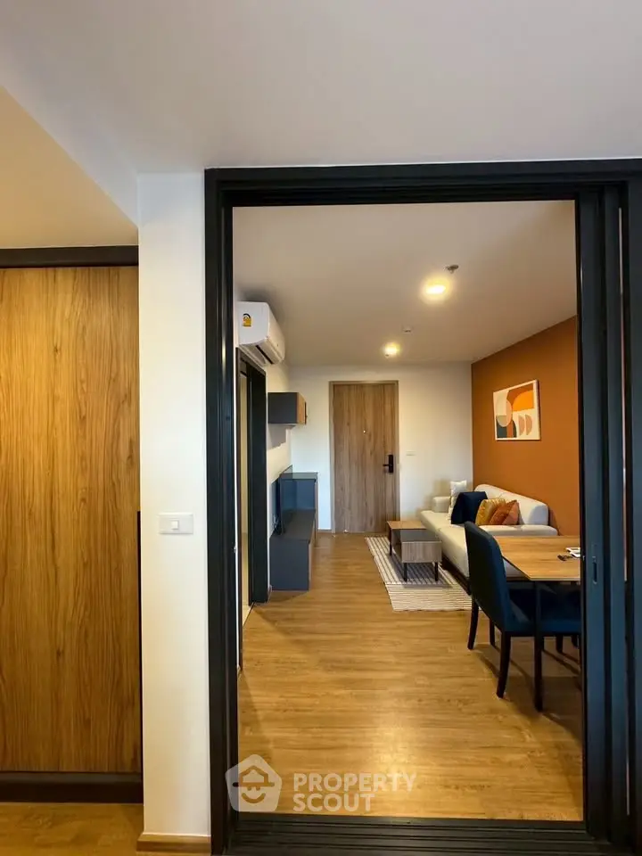 Modern living room with wooden flooring and stylish decor in a cozy apartment.