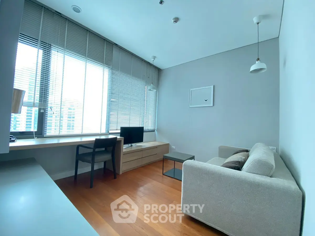 Modern living room with sleek furniture and large window