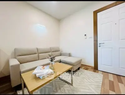 Cozy living room with modern beige sofa and stylish wooden coffee table in a bright apartment.