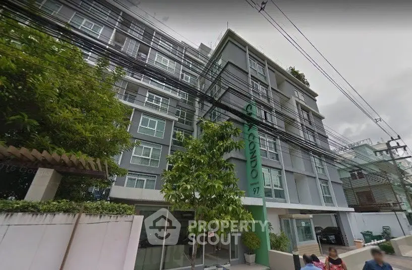 Modern apartment building with lush greenery and contemporary design, perfect for urban living.
