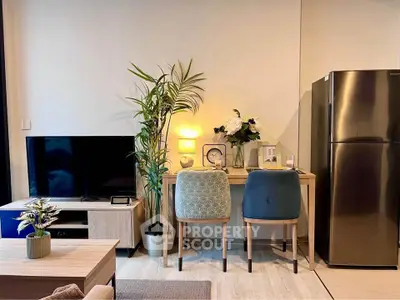 Modern living room with stylish decor, TV, and dining area in a cozy apartment setting.