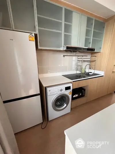 Modern kitchen with sleek appliances and ample storage space