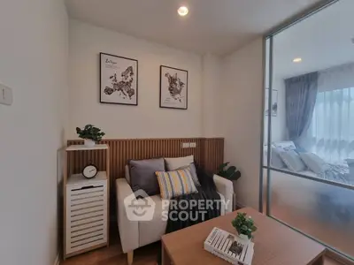 Cozy living room with modern decor and glass partition leading to bedroom