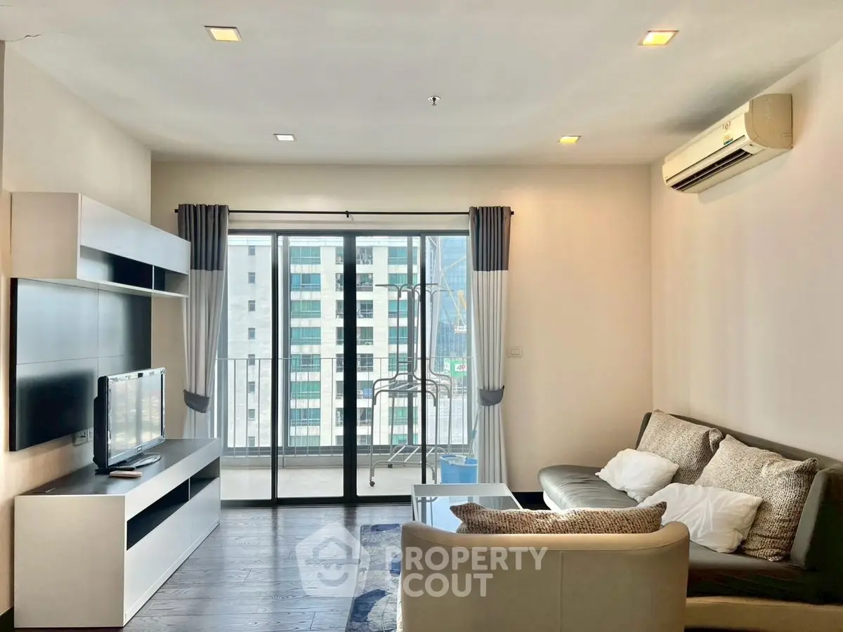 Modern living room with balcony view in high-rise apartment