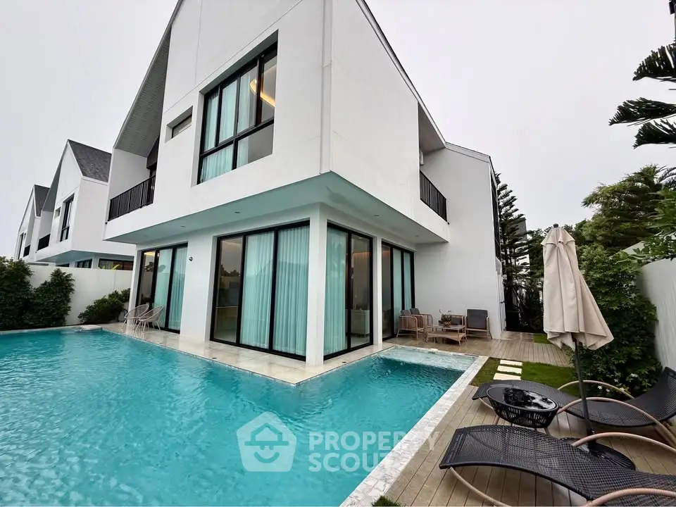 Luxurious modern villa with private pool and stylish outdoor seating area, perfect for relaxation.
