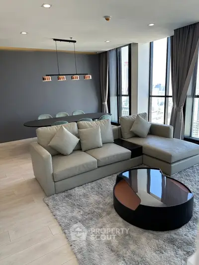 Luxurious modern living room with panoramic city views and elegant furnishings.