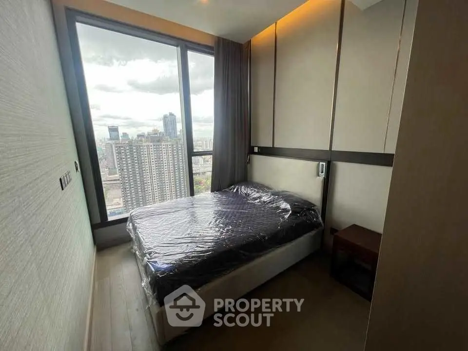 Modern bedroom with large window offering stunning city view