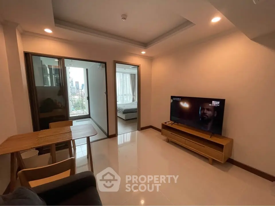 Modern living room with TV and city view, open layout design, cozy and inviting space.