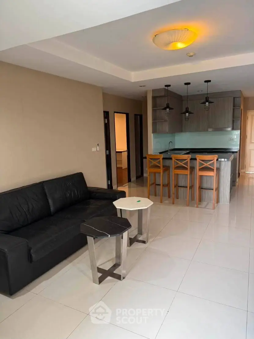 Modern open-layout living room with sleek kitchen and stylish furniture