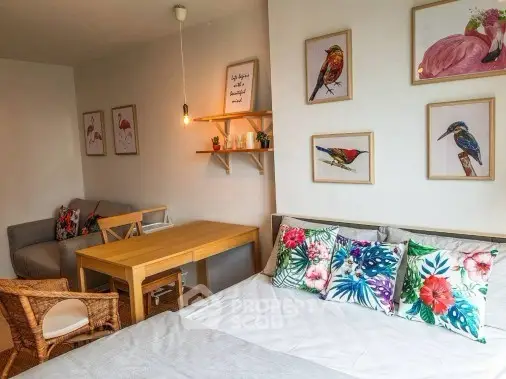 Charming bedroom with vibrant decor and cozy seating area, perfect for relaxation.