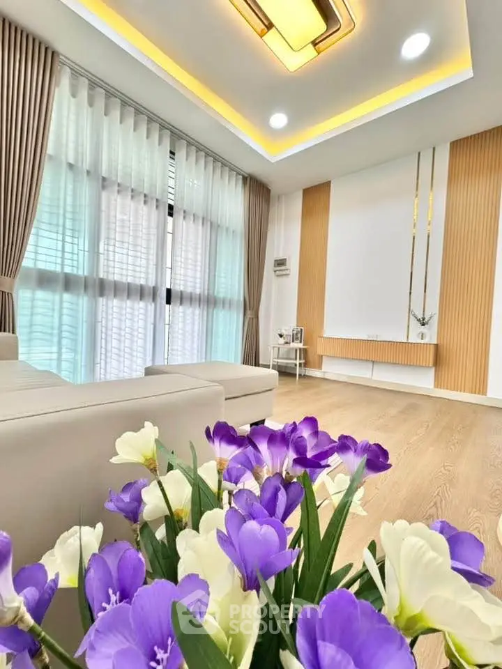 Luxurious living room with modern decor, large windows, and elegant lighting, perfect for relaxation and entertainment.