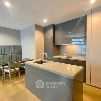 Modern kitchen with sleek cabinetry and dining area in luxury apartment